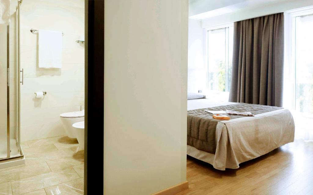 Postel nebo postele na pokoji v ubytování Dama Hotel