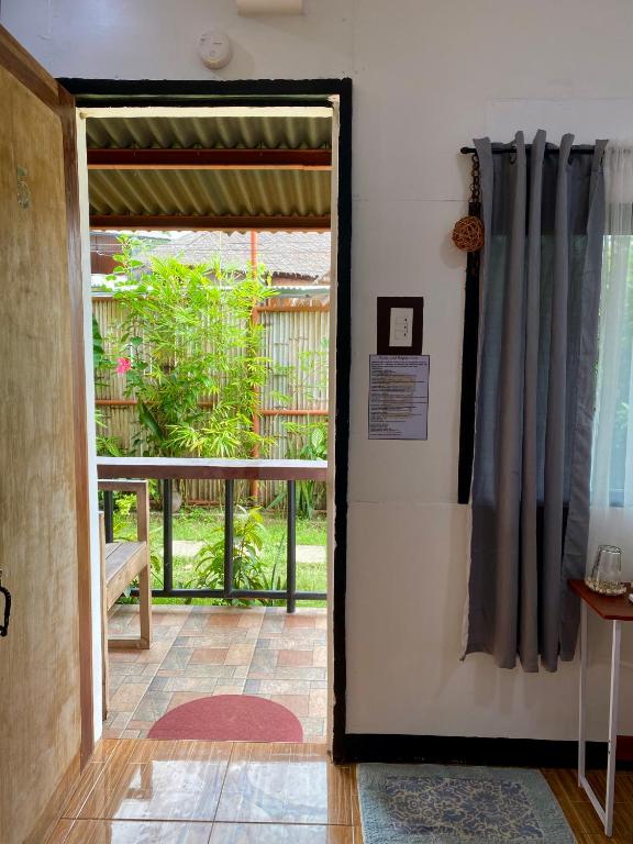 a door leading into a room with a balcony at Moalboal Panagsama beach TopBudz Hostel in Moalboal