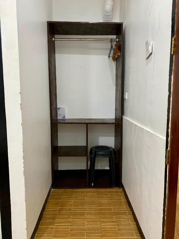 a room with a stool and a shelf and a chair at Moalboal Panagsama beach TopBudz Hostel in Moalboal