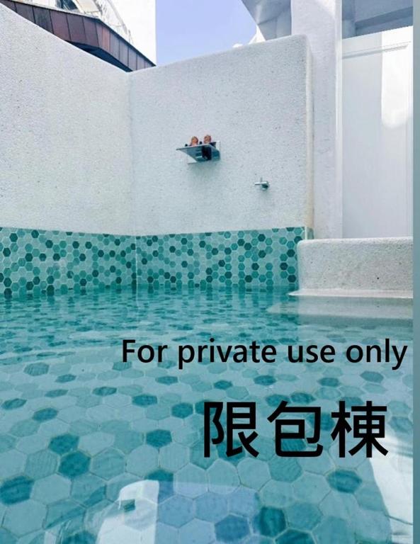 two people sitting in a boat in a swimming pool at Kenting Hostel in Kenting