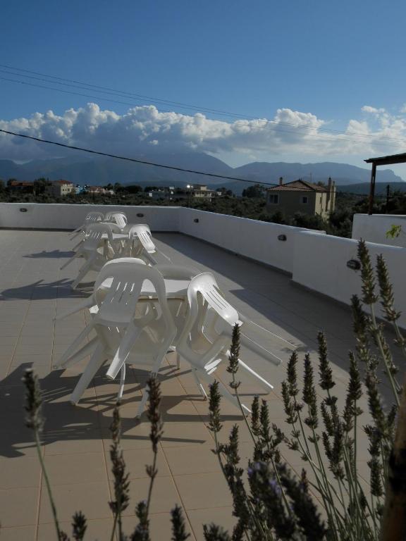 a group of white chairs sitting on top of a roof at Aeolos Hotel Apartments in Gythio