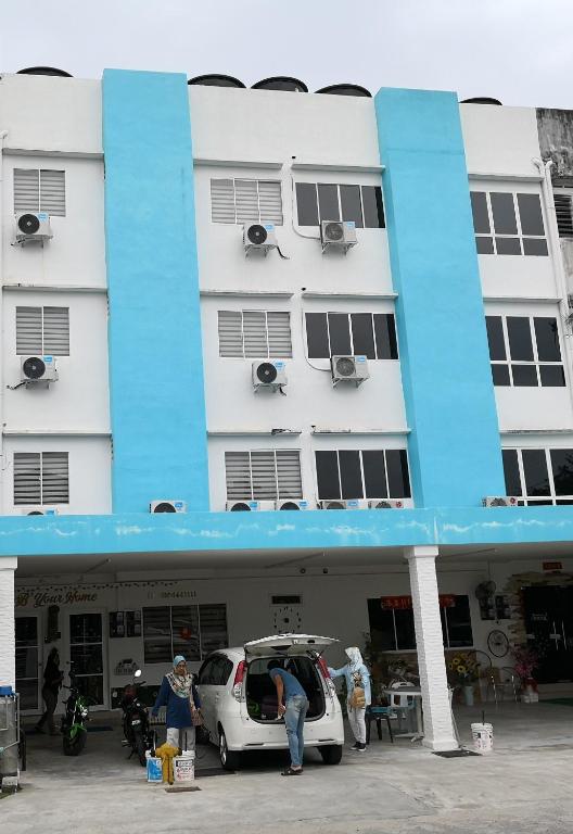 a building with a car parked in front of it at Melaka Stay in Malacca