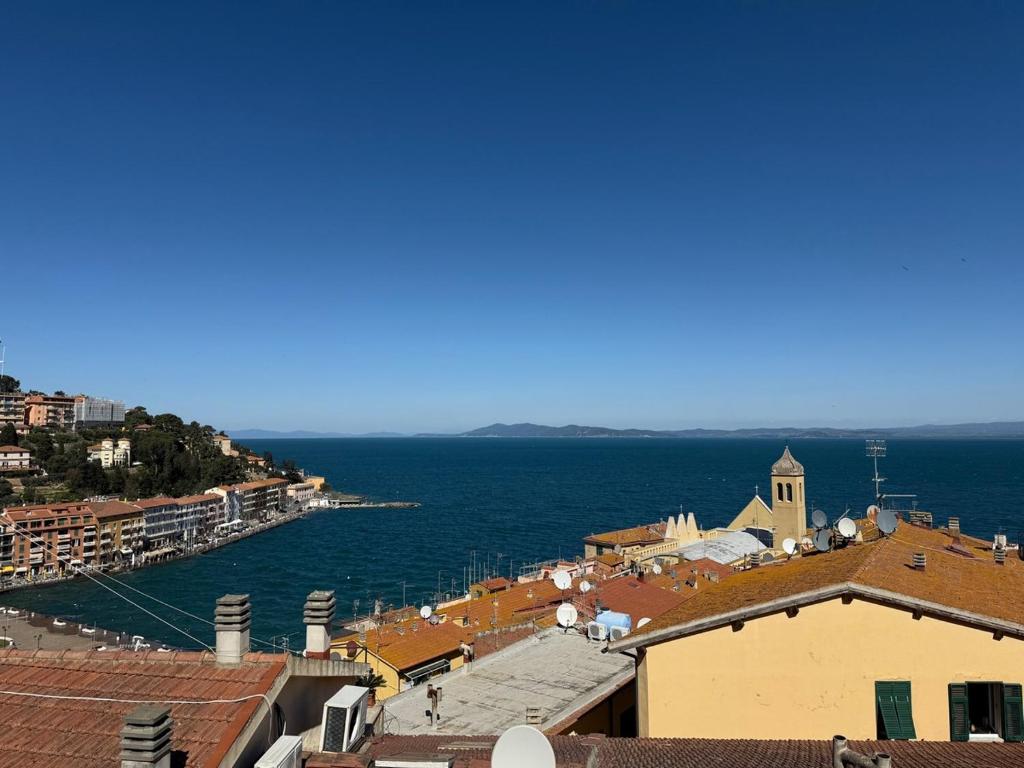 a view of a town with the ocean in the background at Blu Celeste in Porto Santo Stefano