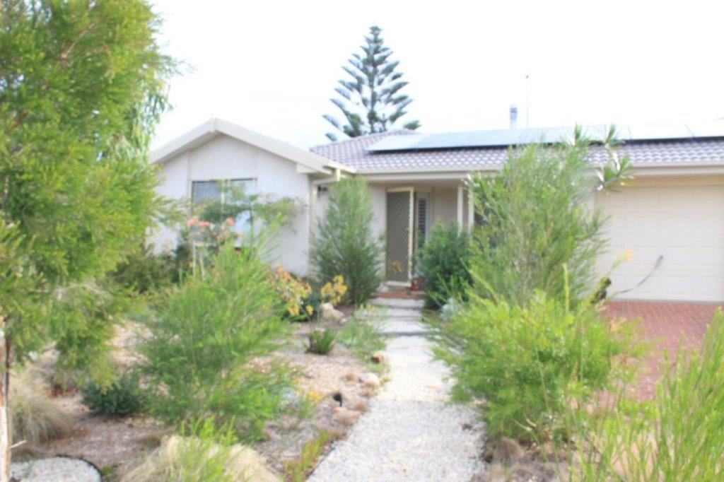 a house with a garden in front of it at Costa Casa Jervis Bay Retreat in Vincentia