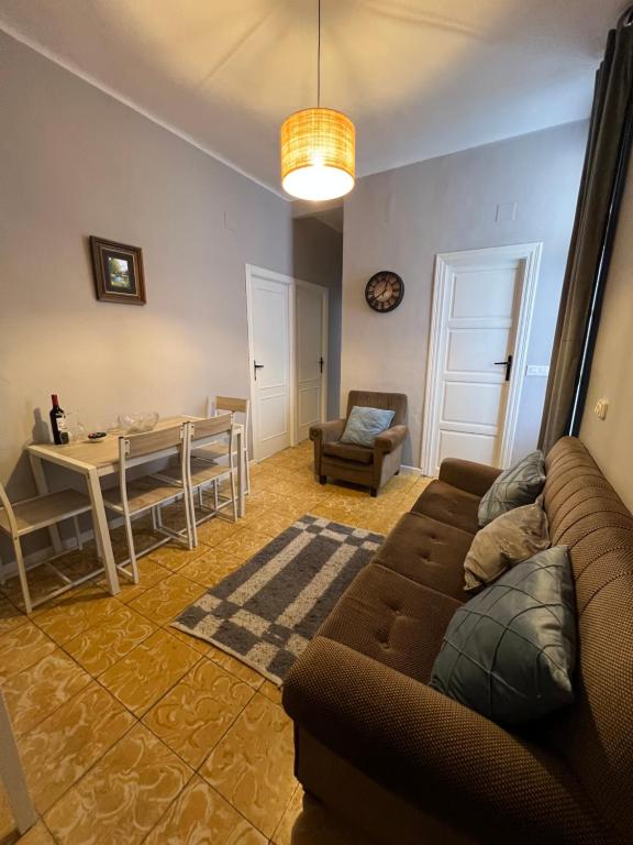 a living room with a couch and a table at Almendra B Vitalba Apartments in Lanjarón