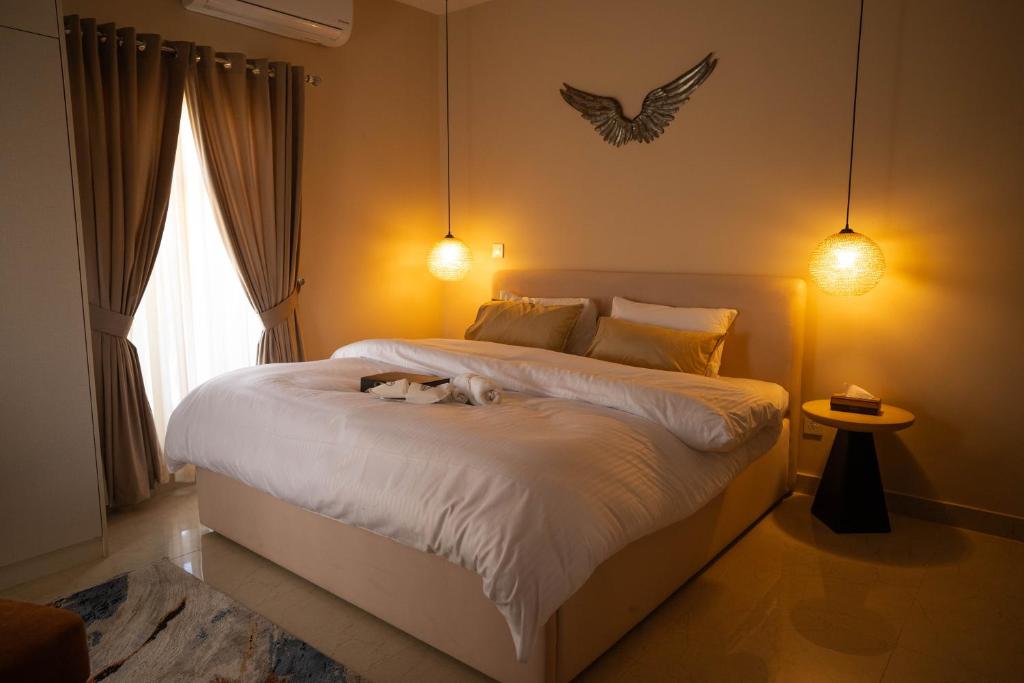 a dog laying on a bed in a bedroom at Just Move Premium 2BR Suite, Near ISB Int'l AIRPT in Islamabad
