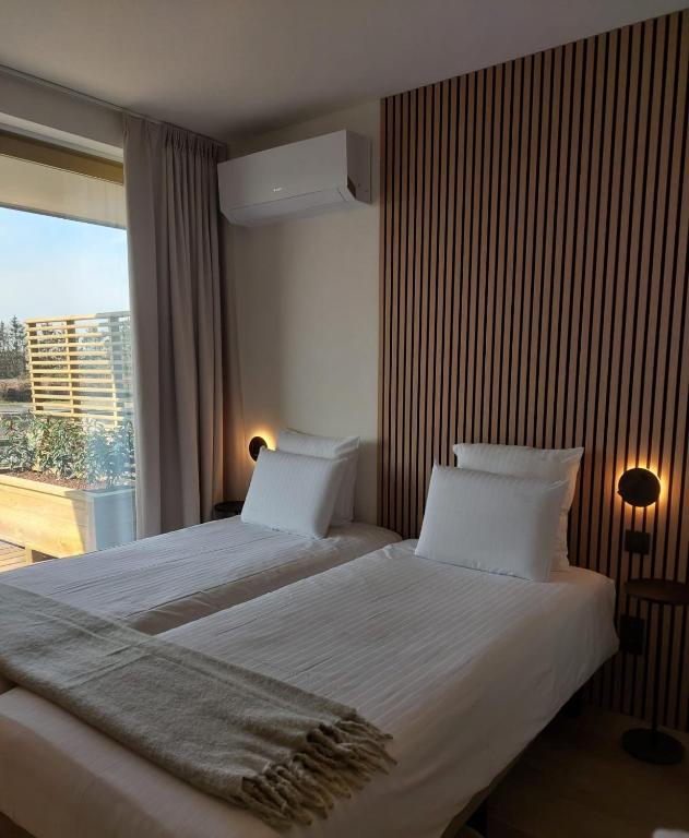 Postel nebo postele na pokoji v ubytování Hotel Essenza