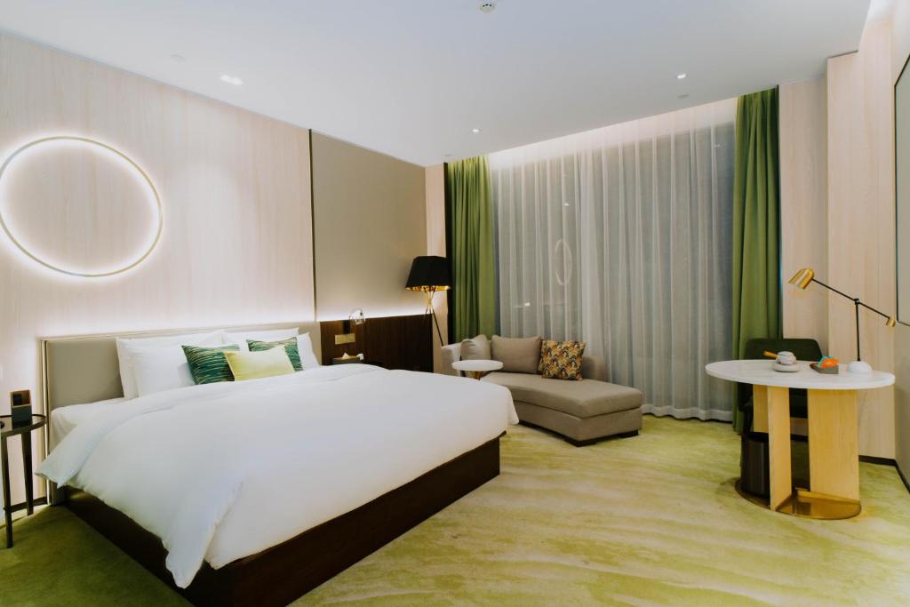 Ένα ή περισσότερα κρεβάτια σε δωμάτιο στο Wuhan Hazens Hotel