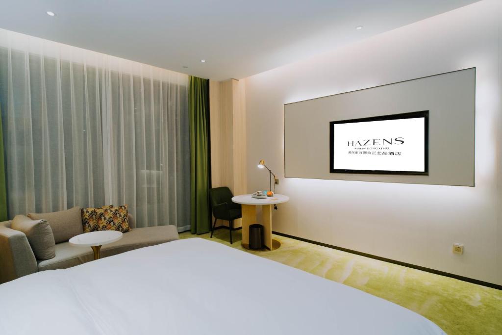 Ένα ή περισσότερα κρεβάτια σε δωμάτιο στο Wuhan Hazens Hotel