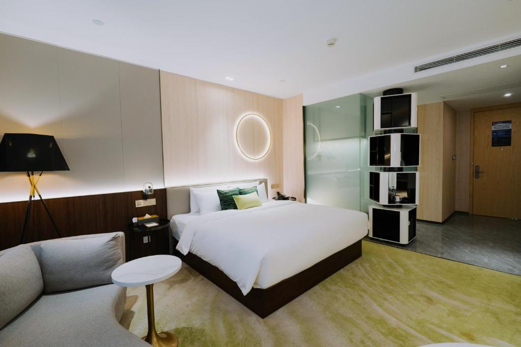 Ένα ή περισσότερα κρεβάτια σε δωμάτιο στο Wuhan Hazens Hotel