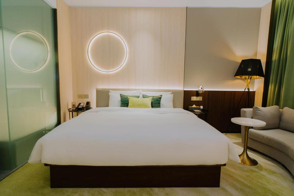 Ένα ή περισσότερα κρεβάτια σε δωμάτιο στο Wuhan Hazens Hotel