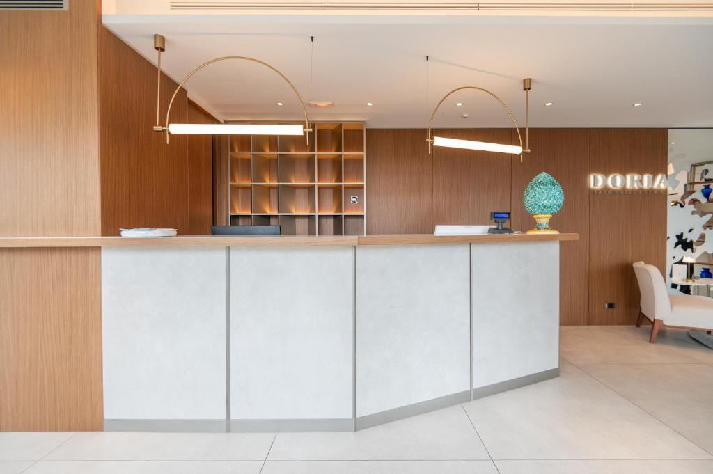 an office lobby with a counter in the middle at Doria Park Hotel in Lerici