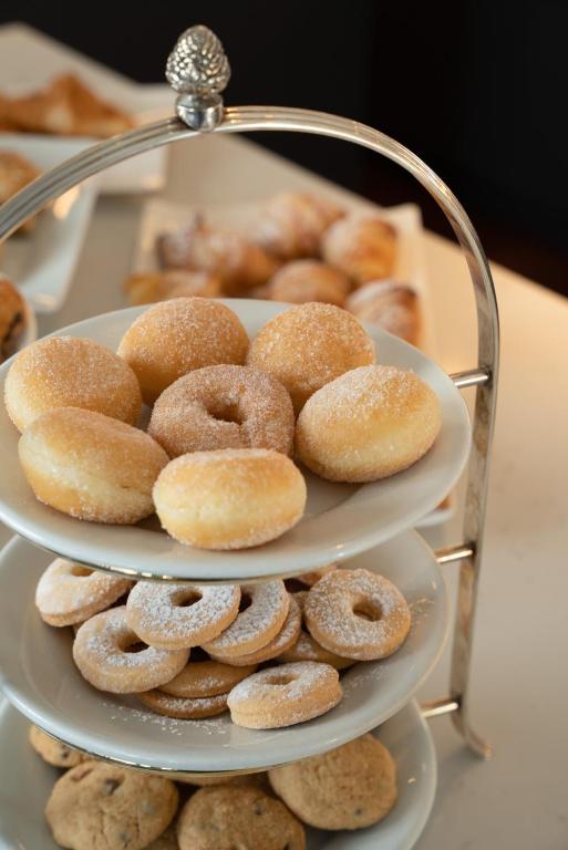 a pile of donuts on a three tiered plate at Doria Park Hotel in Lerici
