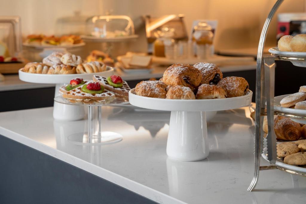 a buffet line with pastries and desserts on plates at Doria Park Hotel in Lerici