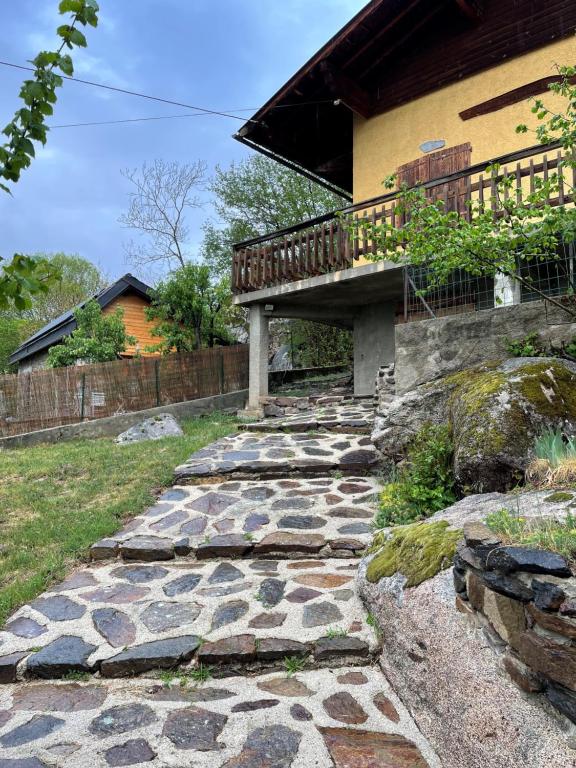a stone walkway leading to a house with a balcony at Chalet familial cerdan à Dorres in Dorres