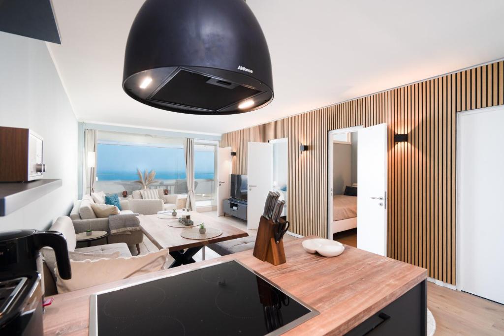 a living room with a large black ceiling at Panoramic Sierksdorf App A12-1 in Sierksdorf