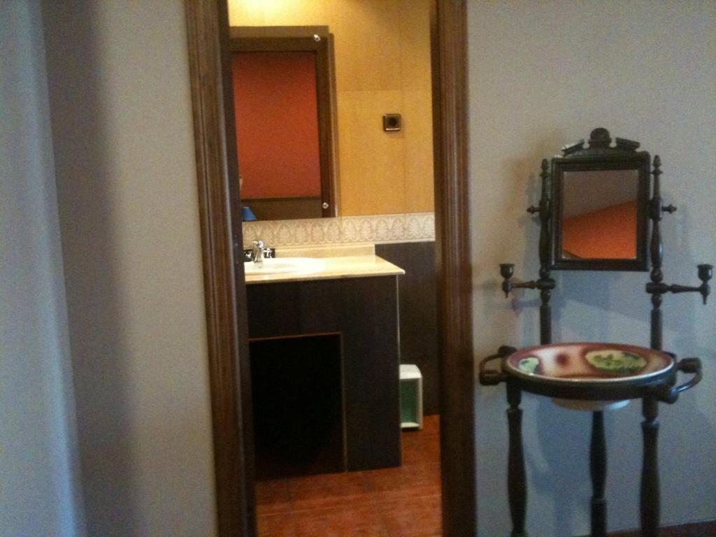 a bathroom with a sink and a mirror at Hotel El Balcón in Avilés