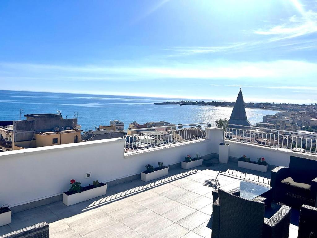 a balcony with a view of the ocean at Luxury Penthouse Sea View with terrace in Giardini Naxos