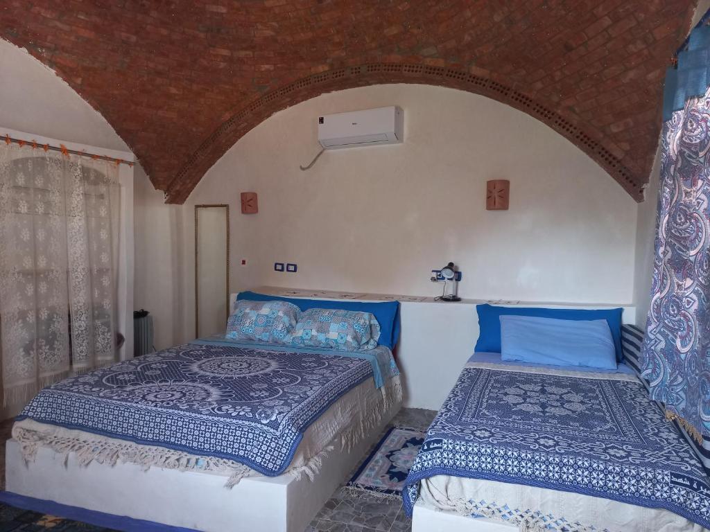 Postel nebo postele na pokoji v ubytování Nubian Lotus