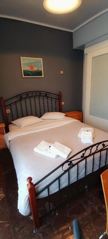 a bedroom with a large bed with white sheets at Orsiida sea view apartment Agria in Agria