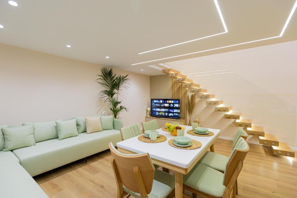 a living room with a table and a couch at Arial Lofts in Vlorë