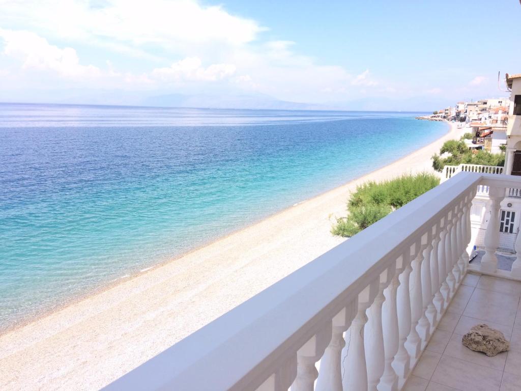 a view of the beach from a balcony at Traditional Maisonette House on the sea shore in Derveni