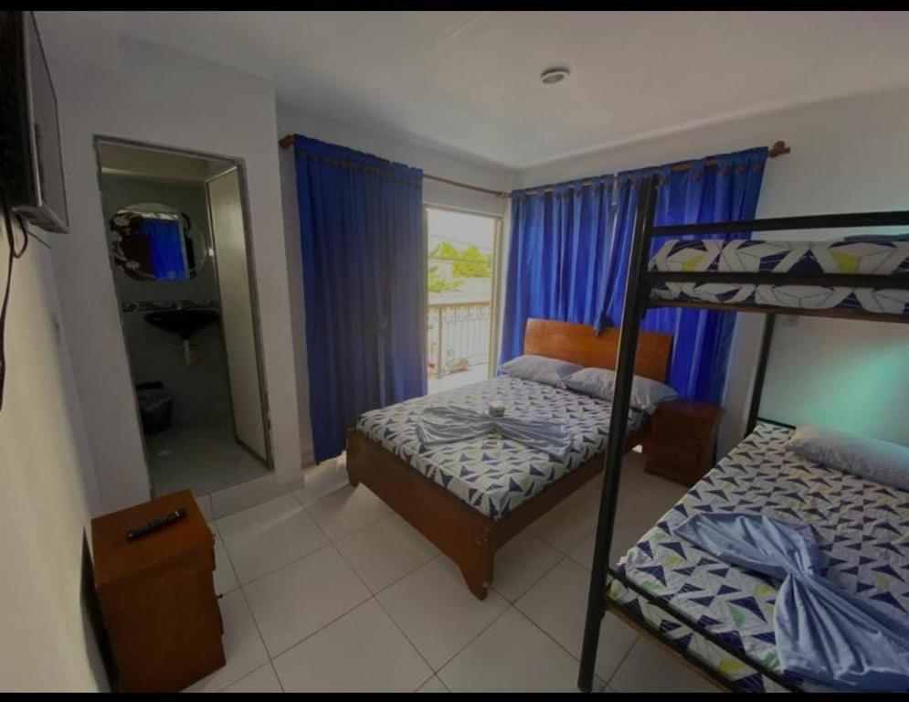 Postel nebo postele na pokoji v ubytování Hotel Los Delfines Melgar