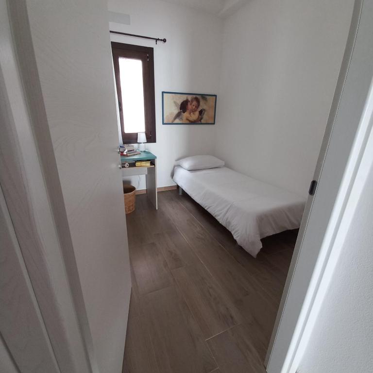 Postel nebo postele na pokoji v ubytování WindwoW - Your flat in Baunei