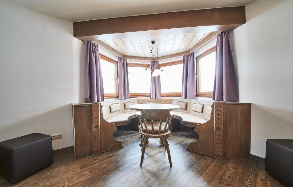 a room with a table and chairs and a window at Chalet Fabian by we rent, JOKERCARD INCLUDED in Saalbach-Hinterglemm