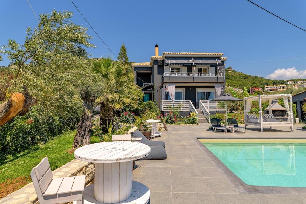 a house with a pool and a table and chairs at Semeli Art House 2 in EFL
