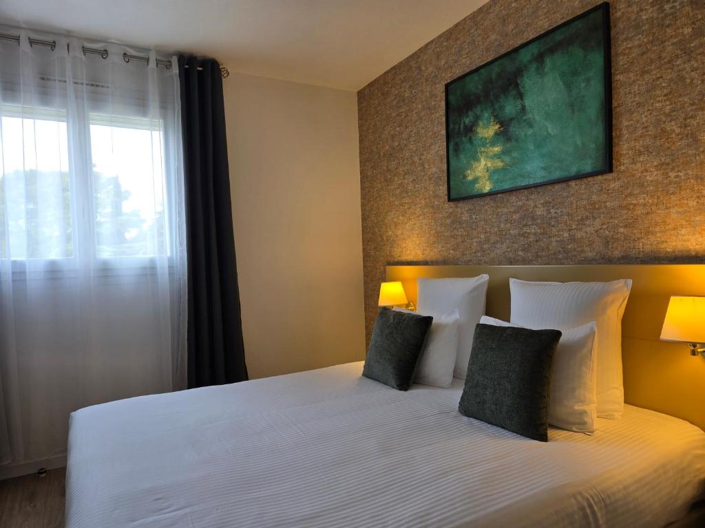 Postel nebo postele na pokoji v ubytování Hôtel Le SAINT-GENIÈS