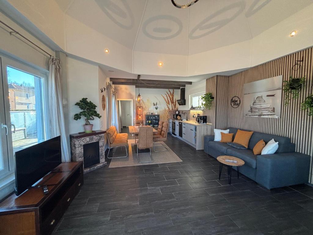 a living room with a couch and a fireplace at Ferienhaus Seepanorama-Marina Mücheln Geiseltalsee in Mücheln