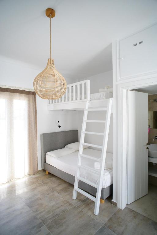 a white bunk bed with a ladder and a chandelier at Casa di Flora in Loutra