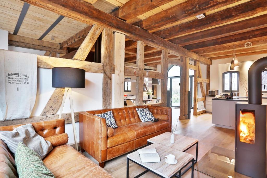 a living room with a couch and a fireplace at Backsteinspeicher Stralsund in Stralsund