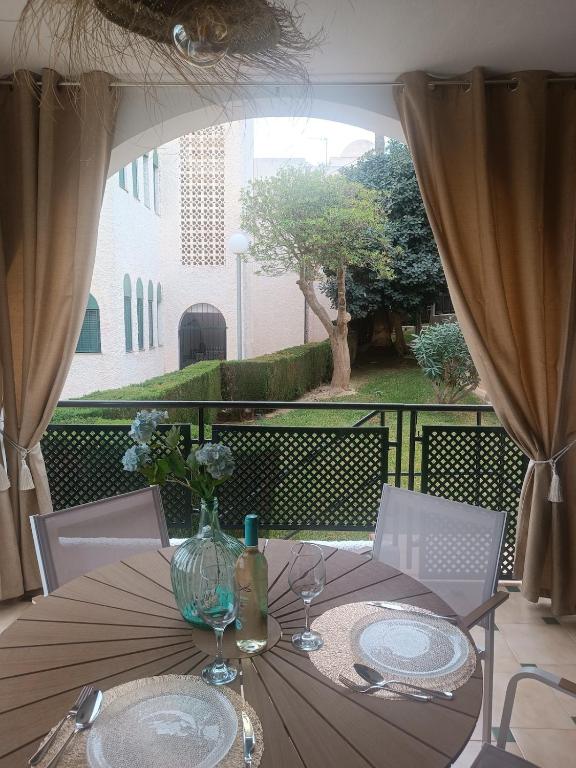a table with a glass vase on top of it at azahar playa apartmento in Mazarrón
