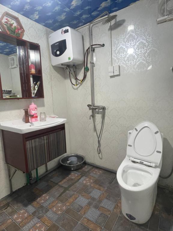 a bathroom with a shower and a toilet and a sink at Rosie Homestay in Ha Giang
