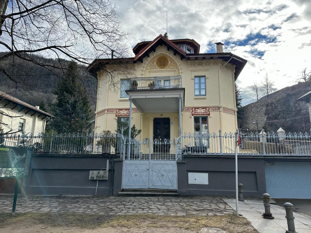 a yellow house with a fence in front of it at Principal Casa Pomar in Camprodon