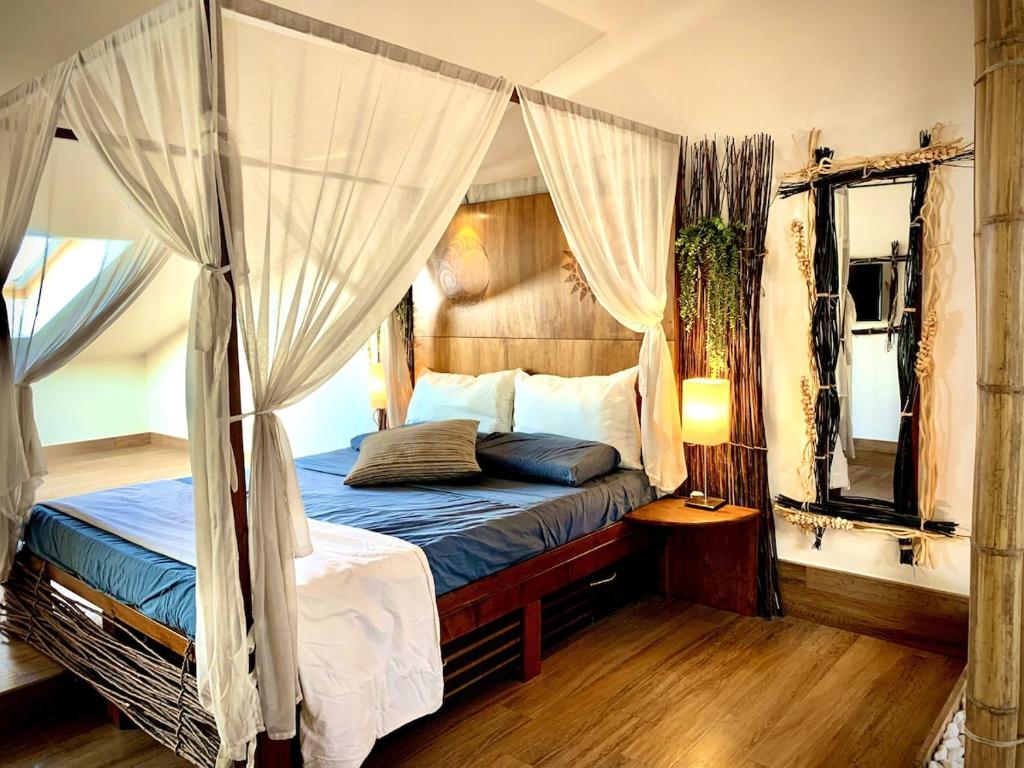 a bedroom with a canopy bed and a tub at Villa Art&Sea -Sea view and Private parking- in Catania