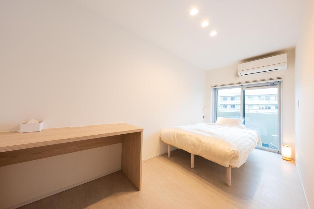 Postel nebo postele na pokoji v ubytování Hotel Meguri