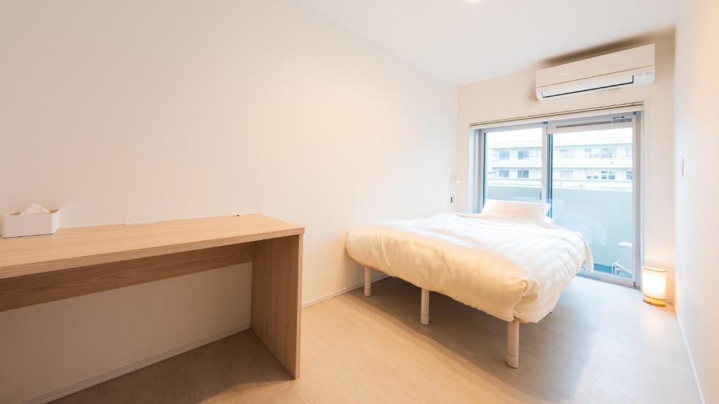 Postel nebo postele na pokoji v ubytování Hotel Meguri