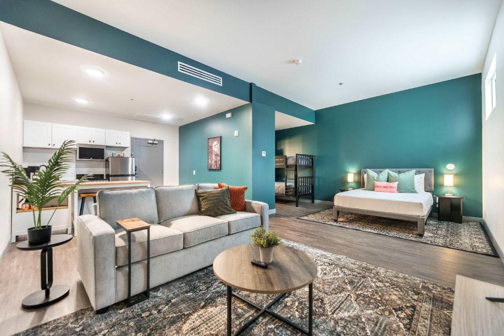 a living room with a couch and a table at Spacious Family Suite Near Cherry St - Sleeps 6! in Macon