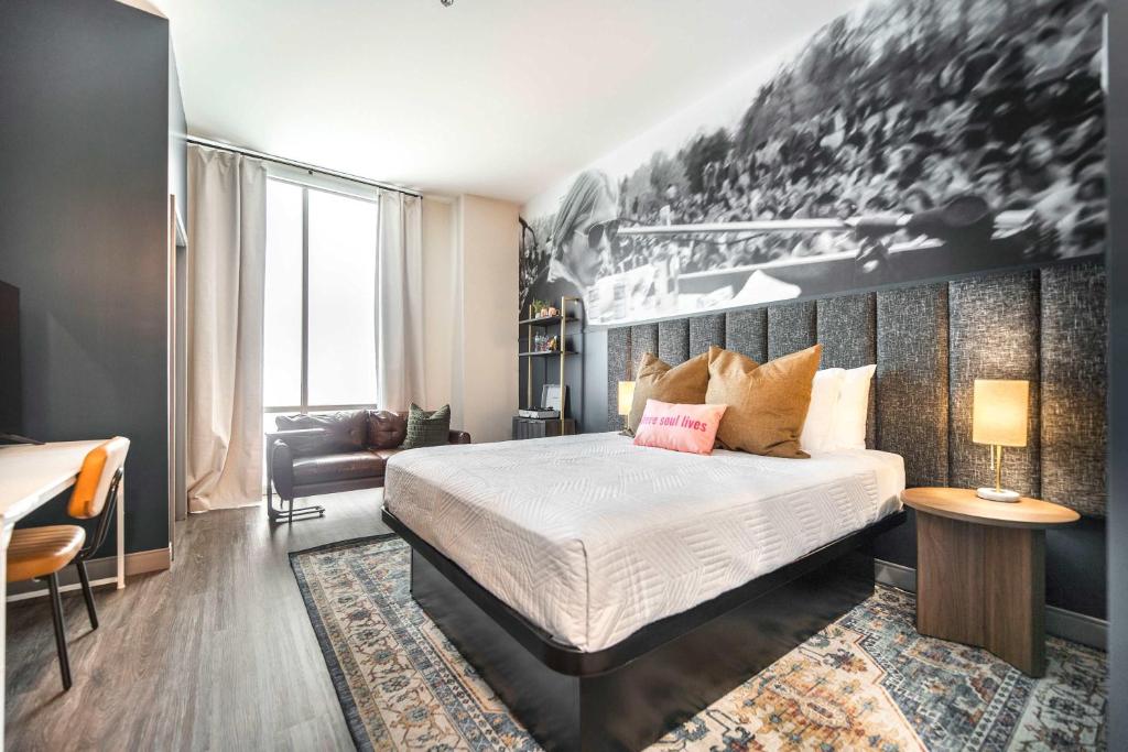 a bedroom with a bed and a couch and a table at Chill Like Gregg Sunlit Southern Vibe in Macon