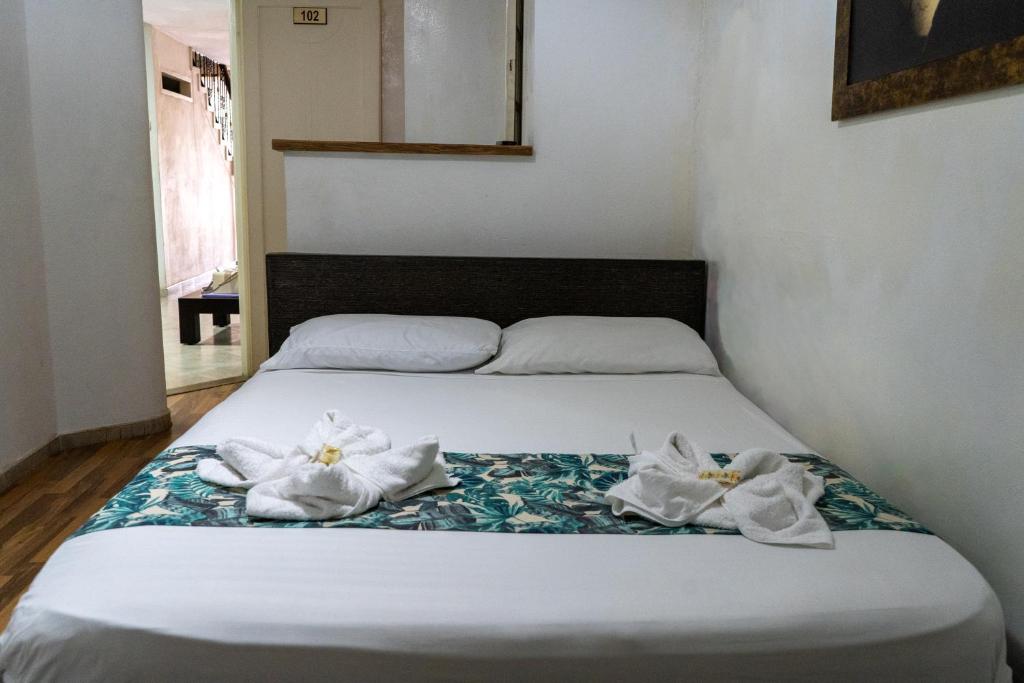 Postel nebo postele na pokoji v ubytování Hotel Portal Guatapé