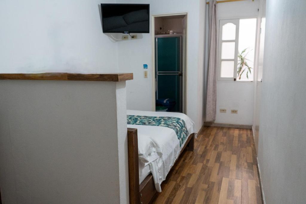 Postel nebo postele na pokoji v ubytování Hotel Portal Guatapé