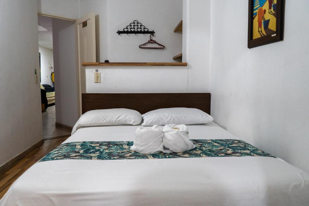 Postel nebo postele na pokoji v ubytování Hotel Portal Guatapé
