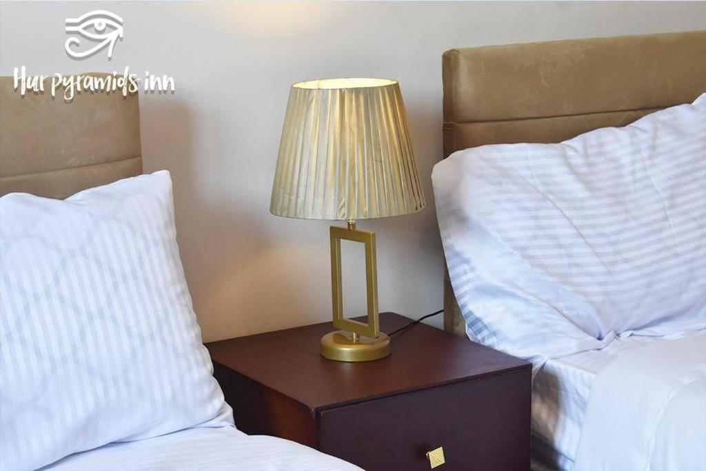 Postel nebo postele na pokoji v ubytování Hur Pyramids Inn