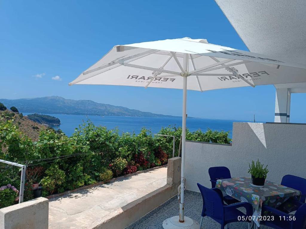 a white umbrella sitting on top of a table at Villa Nertili 1 in (( Kalive Gjoka ))