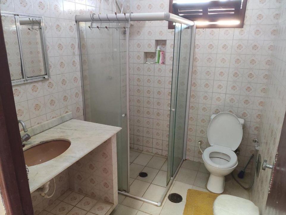 a bathroom with a shower and a toilet and a sink at Village por do sol in Aracaju