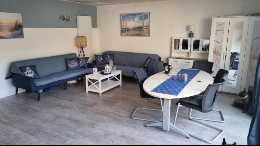 a living room with a blue couch and a table at Vacation home Moselsteg in Brauneberg