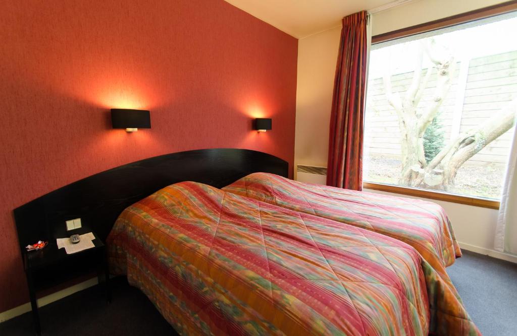 Postel nebo postele na pokoji v ubytování Hôtel Agena